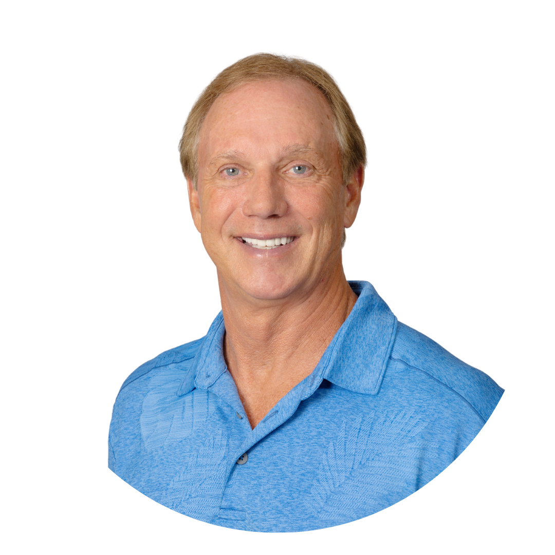 A smiling man with short light brown hair wearing a blue collared shirt. He is facing the camera against a white background.