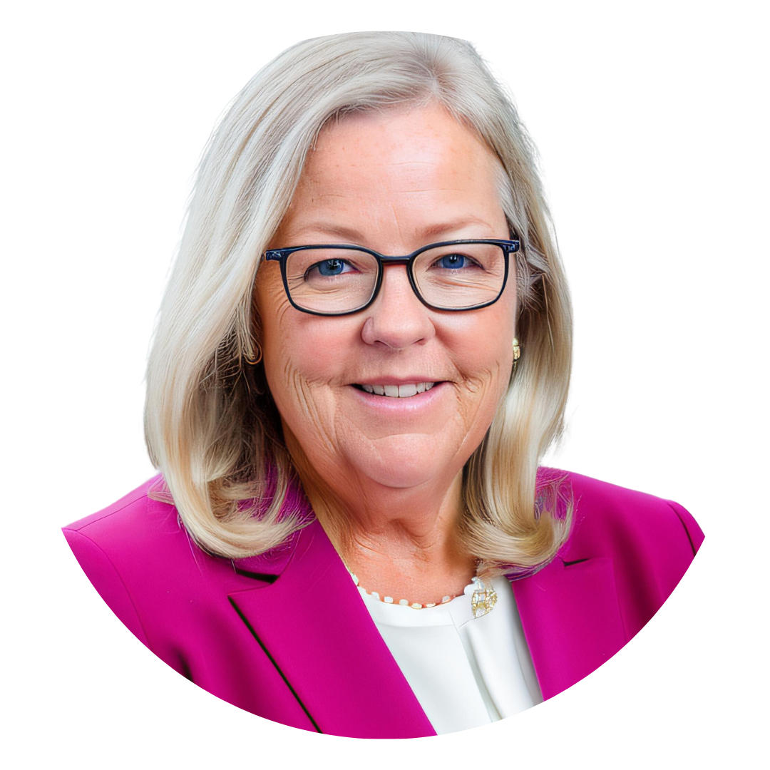 A woman with shoulder-length blonde hair wearing glasses and a pink blazer, smiling against a white background. The image is framed in a circular format.