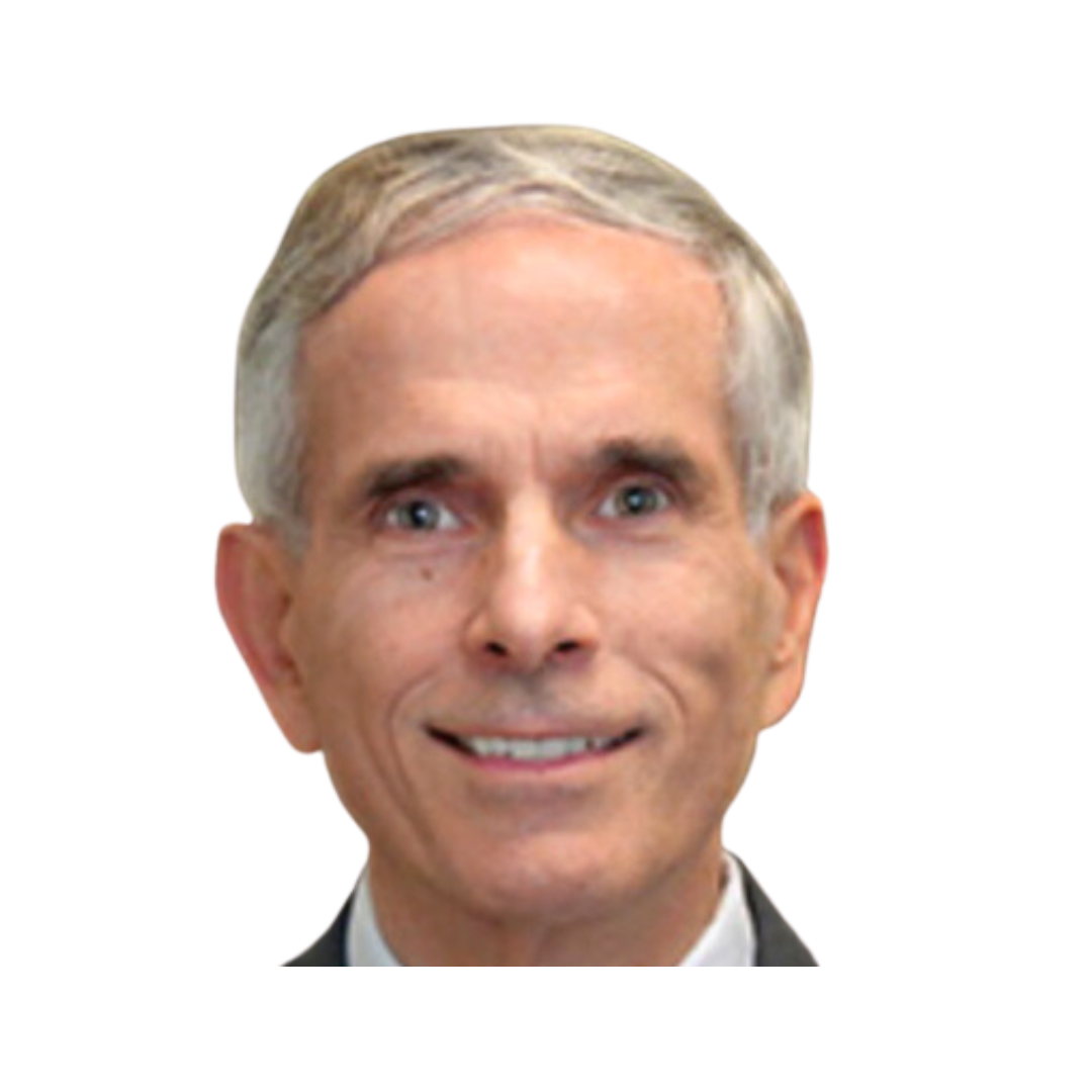 A man with short gray hair and blue eyes smiling at the camera. He is wearing a suit and tie, with a neutral background. The image is cropped in a circular format.