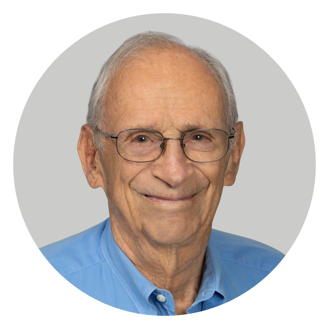 An elderly man wearing glasses and a blue collared shirt against a light gray circular background.