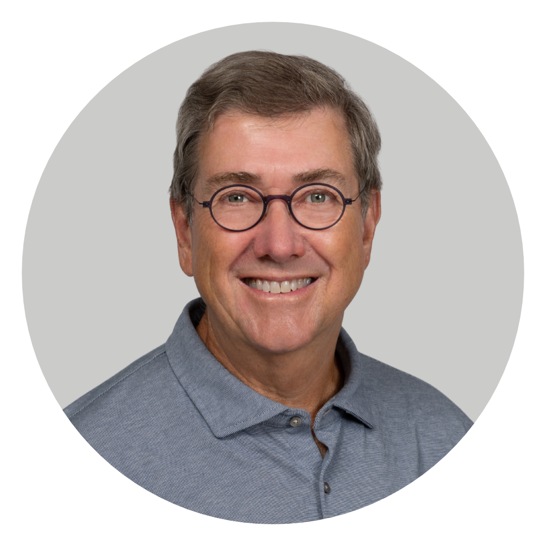 A man wearing round glasses and a gray polo shirt, shown in a circular headshot on a light gray background.